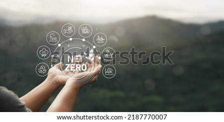 Net Zero icon in hand, carbon neutral and net zero concept. Carbon for a net zero greenhouse gas emissions target weather neutral long term strategy on green background 商業照片 © 