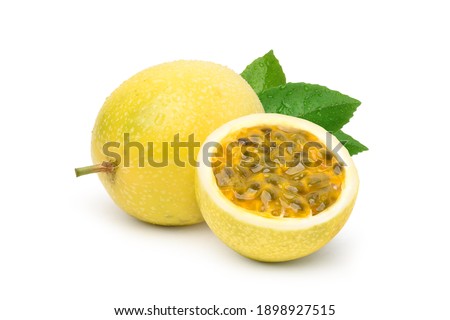 Yellow  passion fruit with cut in half and green leaf isolated on white background.