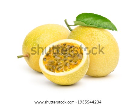 Yellow  passion fruit with cut in half and green leaf isolated on white background.