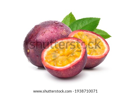 Purple passion fruit (Passiflora edulis) with cut in half and green leaf isolated on white background.