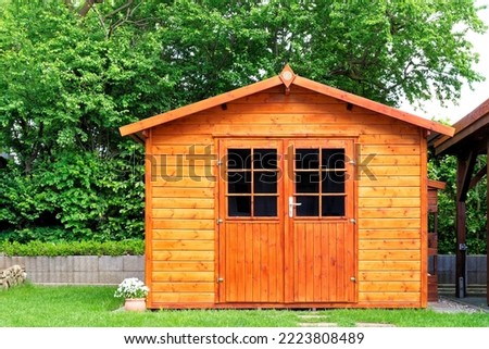 Frontal view of wooden garden shed glased in teak color Foto d'archivio © 