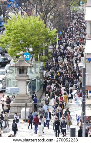 TOKYO - APRIL 11 2015: Crowds of people walking through Harajuku on Saturday April 11 2012. Harajuku is known internationally as a center of Japanese youth culture and fashion.