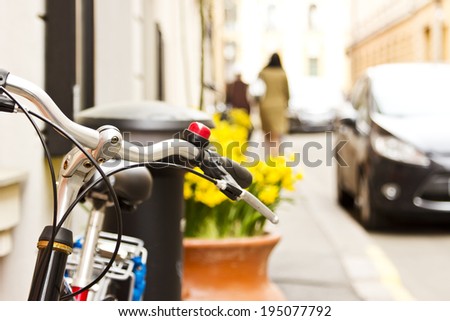 Bicycle near the wall at the street. Image with bokeh town background