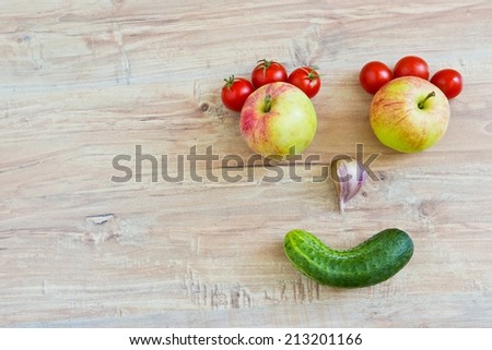 Funny smiling face. Conceptual horizontal image with vegetables. Objects at the right part of image