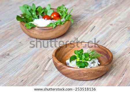 Two kinds of salads in wooden bowls: with vegetables and with  beef tongue