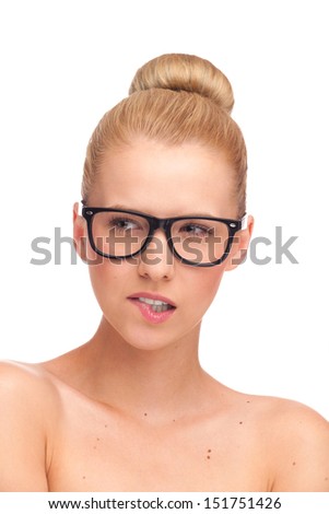 Portrait of beautiful girl in glasses, looking away and biting lip. Studio shot isolated on white.