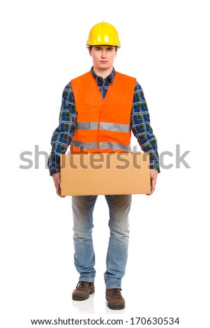 Construction worker holds heavy package. Full length studio shot isolated on white.