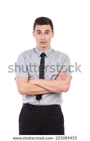 Surprised young man posing with arms crossed. Three quarter length studio shot isolated on white.