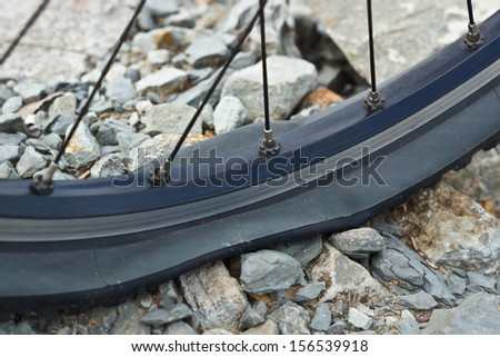 bicycle flat tire on rocks