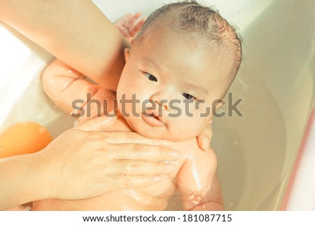 take a bath for a young asian baby