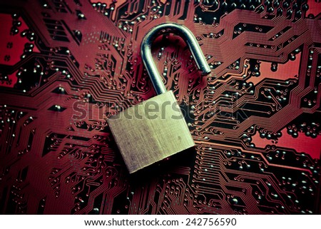 unlock security lock on computer circuit board - computer security breach concept