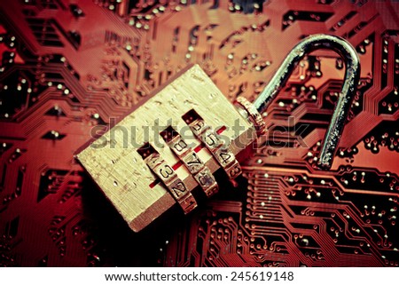 broken unlock security lock on computer circuit board - computer security breach concept