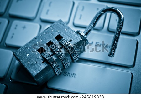 damaged and broken security lock on computer keyboard / computer security breach