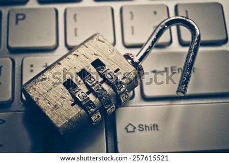 damaged metal security lock with password on computer keyboard - security concept in computer