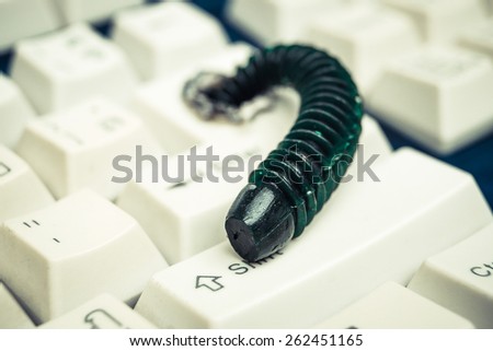 computer worm attacking computer system by penetrating a computer button on a keyboard - worm infection
