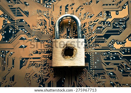 A penetrated security lock with a hole on computer circuit board background