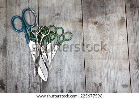 Old rusty sewing scissors on wooden surface. Old tailor scissors