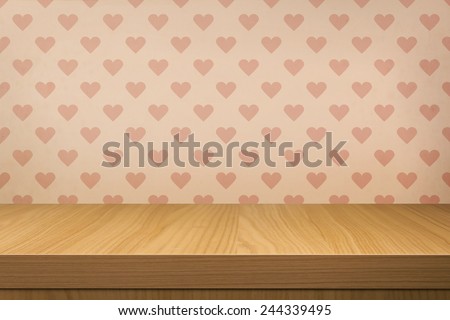 Empty wooden table over vintage wallpaper with pattern of love hearts. Valentine\'s Day. Ready for product montage display