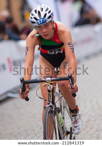 STOCKHOLM - AUG, 23:  World Triathlon  event Aug 23, 2014. woman bikes in Old town, Stockholm, Sweden. Melanie Santos, POR.