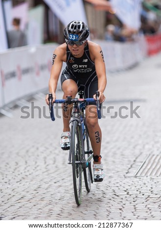 STOCKHOLM - AUG, 23:  World Triathlon  event Aug 23, 2014. woman bikes in Old town, Stockholm, Sweden. Yurie Kato. JAP.