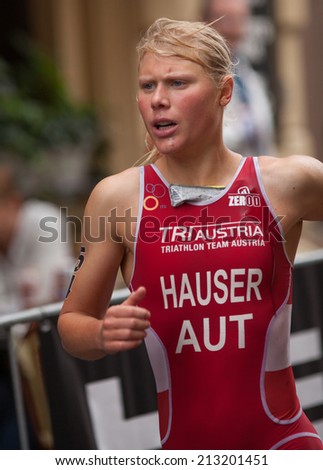 STOCKHOLM - AUG, 23:  World Triathlon  event Aug 23, 2014. woman running in Old town, Stockholm, Sweden. Julia Hauser, AUT.