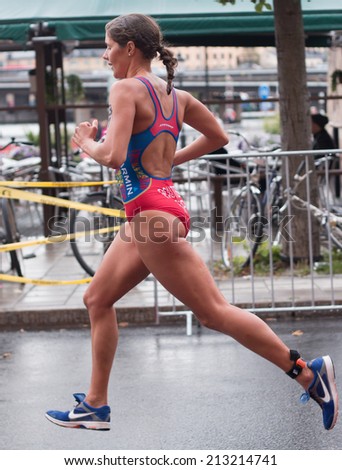 STOCKHOLM - AUG, 23:  World Triathlon  event Aug 23, 2014. woman running in Old town, Stockholm, Sweden. Carolina Routier, ESP.