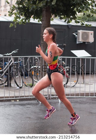 STOCKHOLM - AUG, 23:  World Triathlon  event Aug 23, 2014. woman running in Old town, Stockholm, Sweden. Melanie Santos, POR.