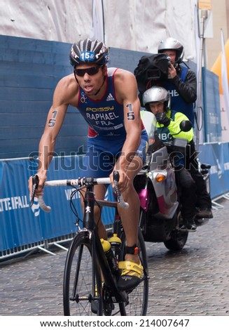 STOCKHOLM - AUG, 23:  World Triathlon  event Aug 23, 2014. man cycle in Old town, Stockholm, Sweden. AURELIEN RAPHAEL, FRA.