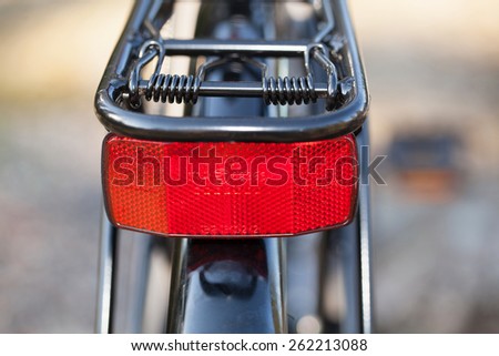 HOLO, SWEDEN, March 20. 2015. A red reflector mounted on the bike luggage carriers.