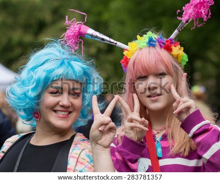 STOCKHOLM, SWEDEN - MAY 31, 2015. Peace and Love Parade. Street party in Stockholm. Two girls make the winning characters.