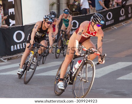 STOCKHOLM - AUG 22: Women ITU World Triathlon event Aug 22 2015. Woman cycling in Old town.  Spirig Nicola (SUI).