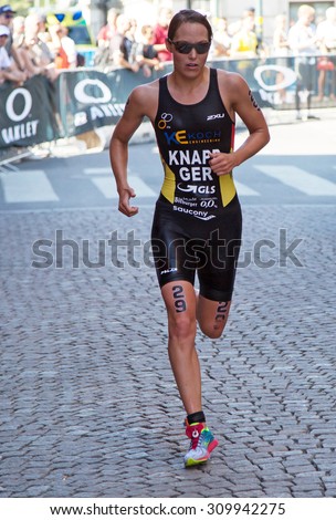 STOCKHOLM - AUG 22: Women ITU World Triathlon event Aug 22 2015. Woman running in Old town.Knapp Anja (GER)