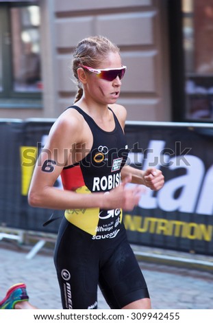 STOCKHOLM - AUG 22: Women ITU World Triathlon event Aug 22 2015. Woman running in Old town.  Robisch, Rebecca.