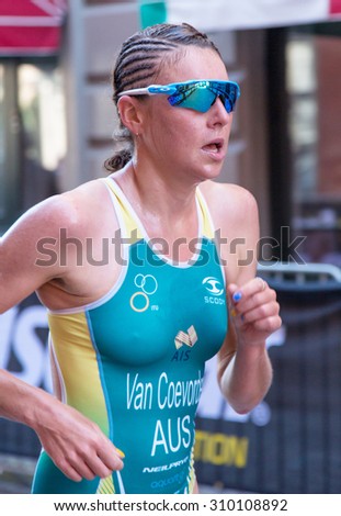STOCKHOLM - AUG 22: Women ITU World Triathlon event Aug 22, 2015. Woman running in Old town. Van Coevorden Natalie (AUS).
