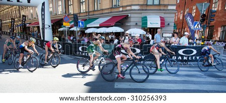 STOCKHOLM - AUG 22: Women ITU World Triathlon event Aug 22 2015. Woman cycling in Old town.