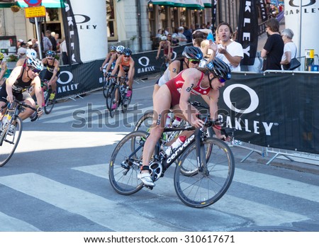 STOCKHOLM - AUG 22: Women ITU World Triathlon event Aug 22 2015. Woman cycling in Old town. Spirig, Nicola (SUI).