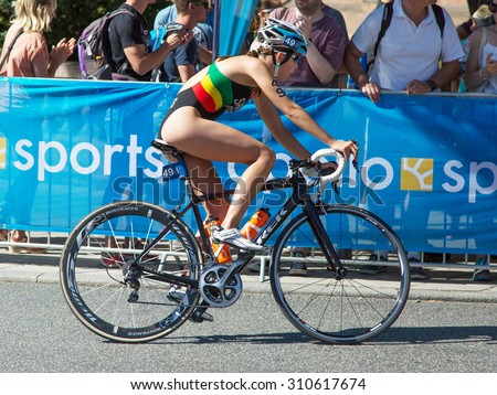 STOCKHOLM - AUG 22: Women ITU World Triathlon event Aug 22 2015. Woman cycling in Old town.Santos, Melanie (POR).