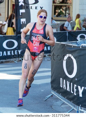 STOCKHOLM - AUG 22: Women ITU World Triathlon event Aug 22 2015. Woman running in Old town. Sarah-Anne Brault CAN.