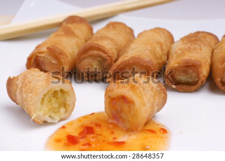 Fried chinese egg roll with chopsticks and sauce