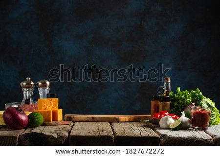 Workplace for cooking meal on dark blue background. Backstage of preparing traditional mexican tacos at the professional restaurant kitchen. Cooking concept.