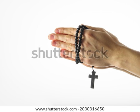 Rosary and crucifixion in female hands. Simple white background. There is an empty space for insertion. Religion, Christianity, Catholicism, spirituality, faith. Photo stock © 
