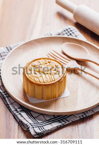 moon cake with salt yolk eggs on wooden dish