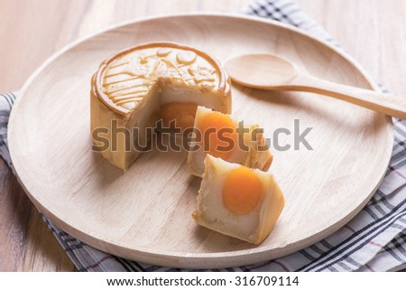 moon cake with salt yolk eggs on wooden dish