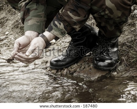 American army soldier washing in stream
