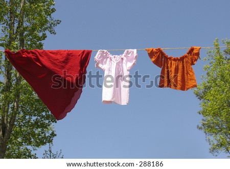 Old fashioned clothing hanging on a line against a blue sky