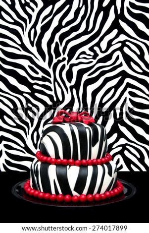 Zebra cake with a red bow with a zebra background