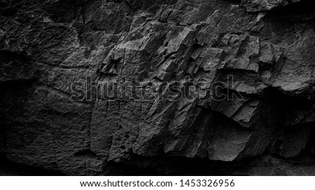 Dark Aged Shabby Cliff Face And Divided By Huge Cracks And Layers. Coarse, Rough Gray Stone Or Rock Texture Of Mountains, Background And Copy Space For Text On Theme Geology And Mountaineering. Foto d'archivio © 