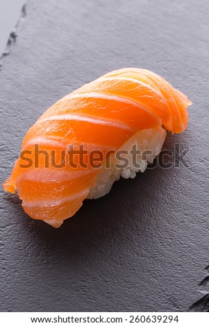 Salmon sushi nigiri on a stone plate