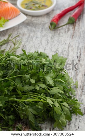 Delicious portion of fresh salmon fillet with aromatic herbs and spices over wooden vintage background