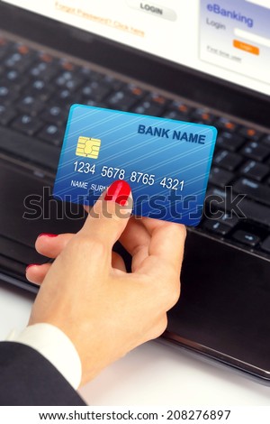Businesswoman holding credit card - e banking / shopping online.